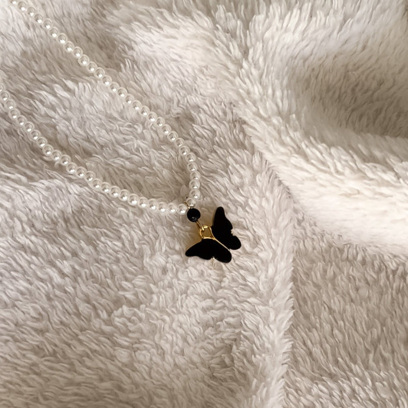elegant pearly necklace with lavastone essential oil diffuser and butterfly